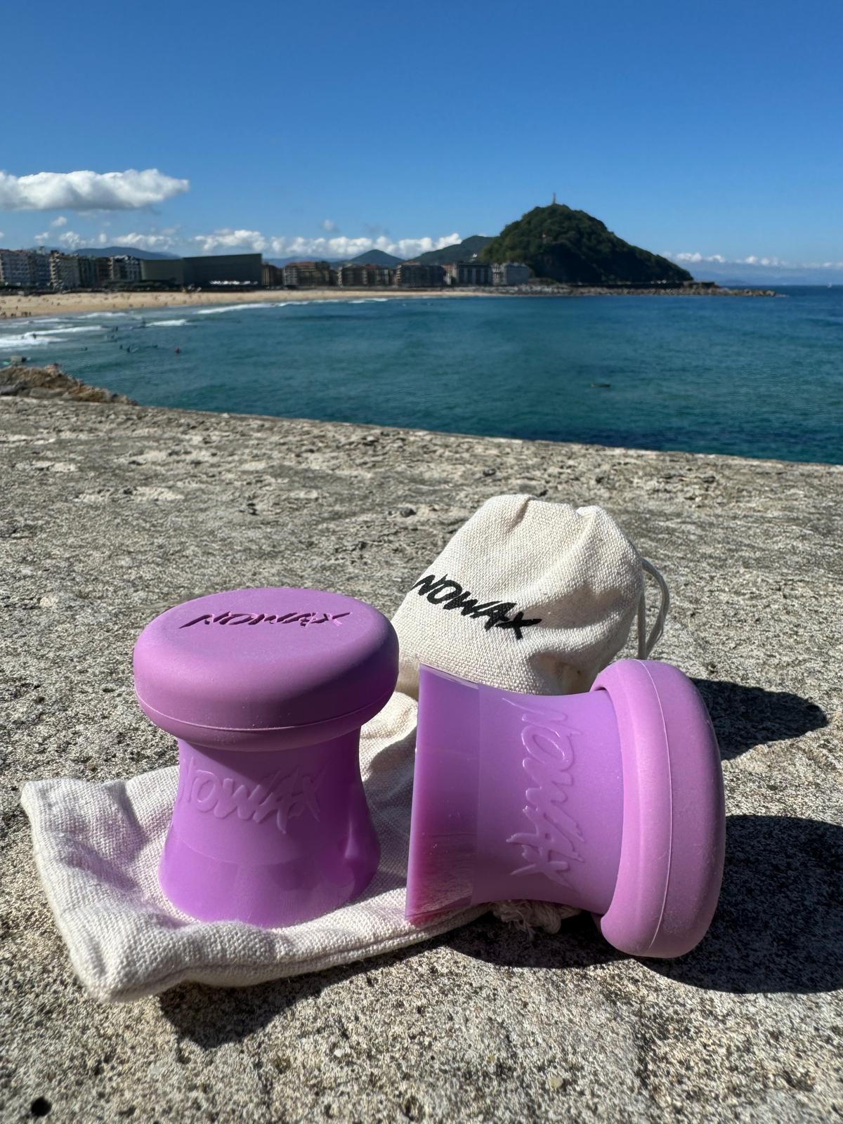 NOWAX surf wax scraper on the beach